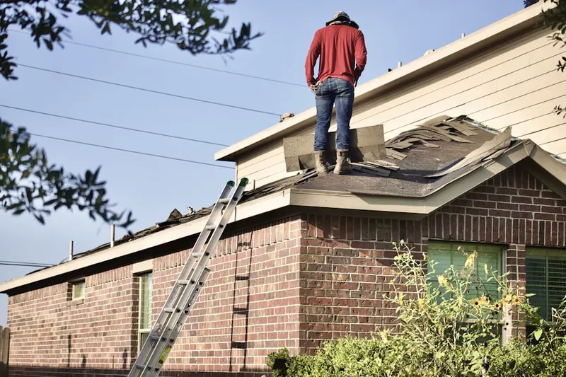 Professional roofer working on a residential roof in Victorville